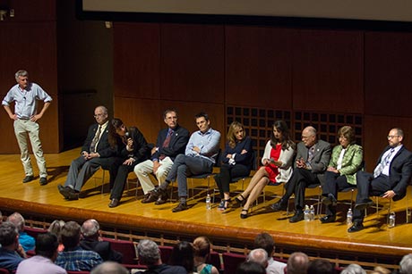 Steve Squyres, professor of astronomy, left, guides symposium speakers during questions and answers at day's end.