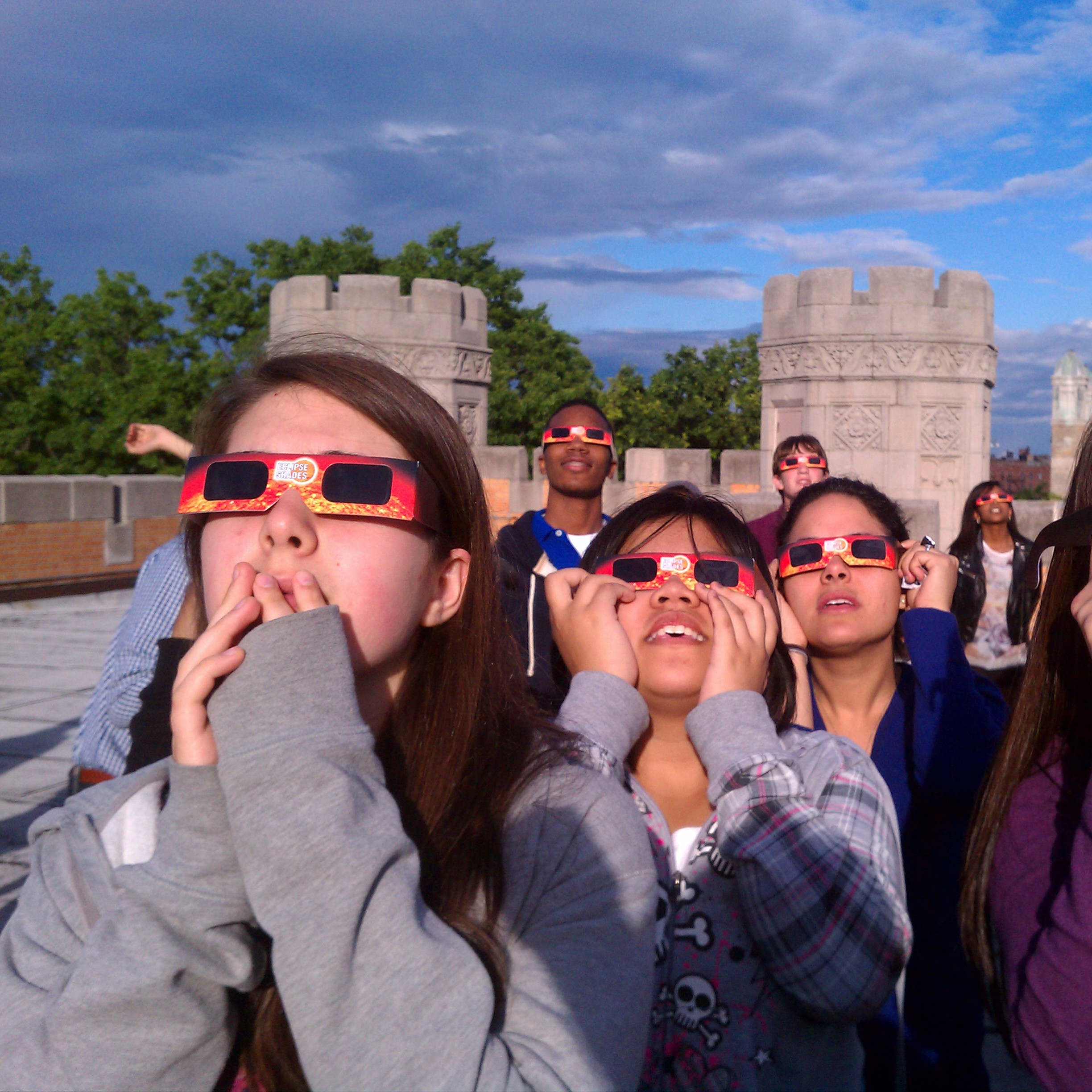 High school students watching the transit from the roof of Lehman College in the Bronx